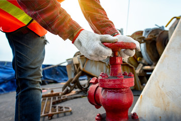 Close up hand opening or closing water valve in fire fighter in jobsite  during training or...
