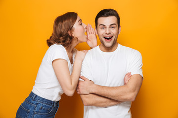Fototapeta premium Excited beautiful couple wearing white t-shirts standing