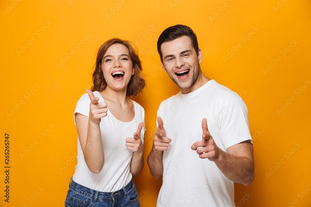 Poster Excited beautiful couple wearing white t-shirts standing