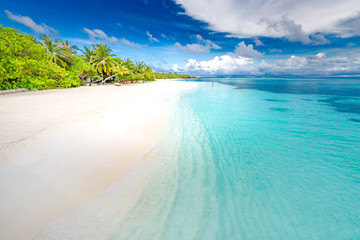 Summer travel destination. Design of summer vacation holiday concept. Perfect tranquil beach scene, soft sunlight and white sand and blue endless sea as tropical landscape