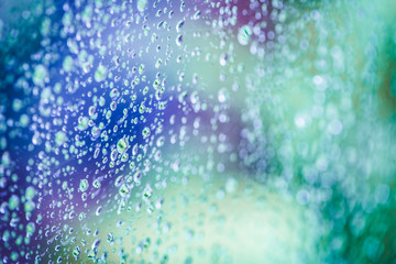 Water drops background. Water drops on glass window over blue sky