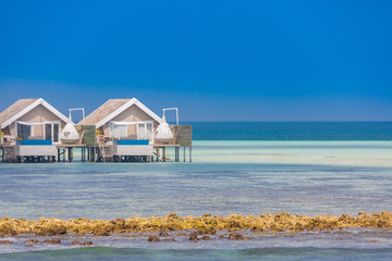 Water villas on Maldives island in the morning