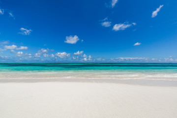Fototapeta na wymiar Closeup of sand on beach and blue summer sky 