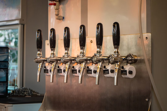 The craft beer taps in a pub.