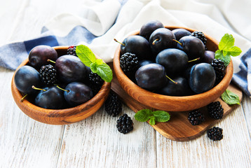 Bowls with fresh plums