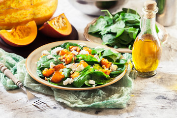 Roasted pumpkin salad with spinach and nuts