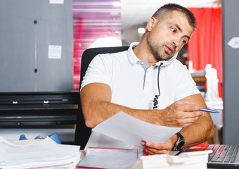 portrait of a working man at printer studio