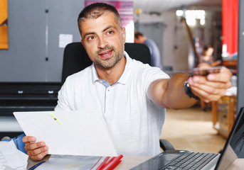 portrait of a working man at printer studio