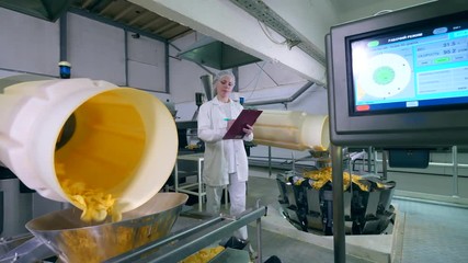 Female expert is observing process of producing crisps