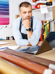 portrait of working advertising agency behind a laptop