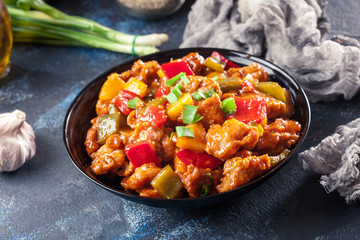 Sweet and sour chicken with colorful bell pepper on a plate