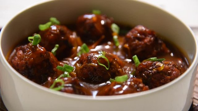 Manchurian balls with gravy - Popular food of India made of cauliflower florets or chicken
