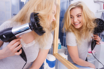 Woman doing curls with hairdryer diffuser