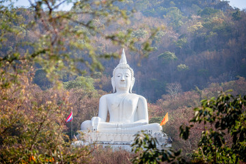 background of the large Buddha statue built on the mountain and surrounded by treeswith inWatThepPhithak Punnaram(Phra Buddha Sakon Sima Mongkhon)is a religious tourism destination in Korat,Thailand