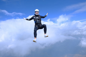 Obraz na płótnie Canvas Girl in leather jacket is flying in the amazing sky.