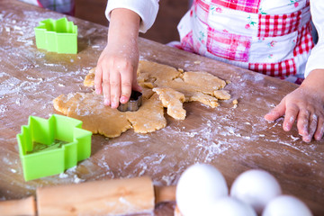Child Chef preparing the dough. Closeup girl's chef's hands with dough and flour, food preparing process