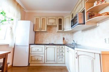Beautiful New Kitchen Interior with Island, Sink, Cabinets and Pendant Lights in New Home