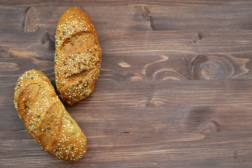 Sesame bun on retro wooden table. Rustic background with copy space