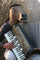 Busker with Horse Mask and Accordion