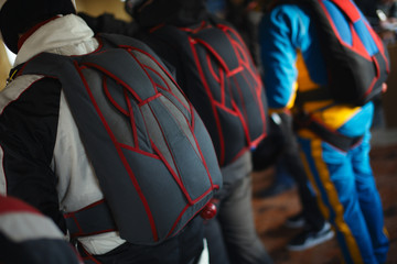 Fototapeta na wymiar Modern sports parachute wing behind the back of an athlete close-up, rear view. Parachute equipment.