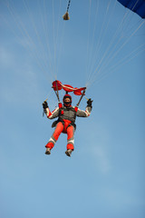 Obraz na płótnie Canvas Young skydiver lands with a parachute close-up.