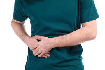 Young man suffering from stomachache on white background