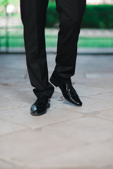 The man goes in black shoes