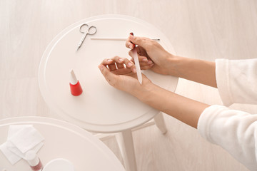 Woman doing manicure at home