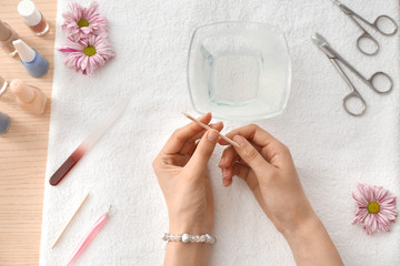 Woman doing manicure at table