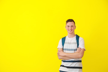 Cute teenage boy on color background