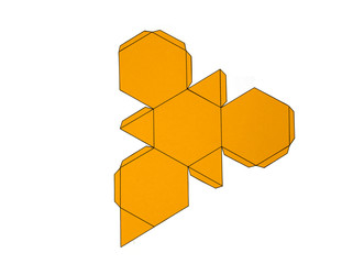 Geometric shape cut out of yellow paper and photographed from above on white background.Geometry net of Truncated tetrahedron. Unfolded three Dimensional Figures. Isolated. Top view.