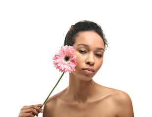 Young African-American woman with flower on white background
