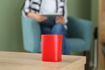 Smart home assistant device on table in room