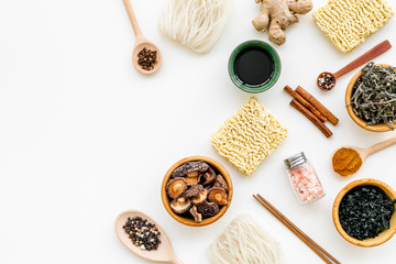 Chinese and Japanese food cooking with ginger, spices and noodles on white background top view mockup