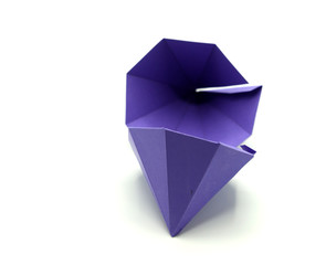 Geometric shape cut out of purple paper and photographed from above on white background. Geometry net of Octagonal Dipyramid. 2D shape that can be folded to form a 3D shape or a solid.