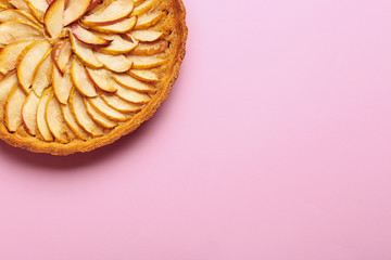 Tasty apple pie on color background