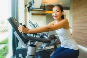Fototapeta na wymiar Portrait beautiful young sport asian woman exercise and work out with fitness equipment in gym