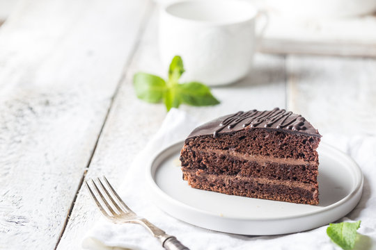 Delicious Chocolate Prague Cake On Plate Over White Background