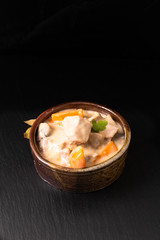 Classic French food concept Blanquette de Veau or Veal in White Wine Sauce in handmade ceramic cup with copy space