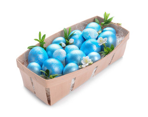 Box with beautiful Easter eggs on white background