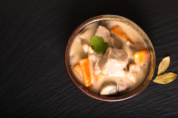 Classic French food concept Blanquette de Veau or Veal in White Wine Sauce in handmade ceramic cup with copy space