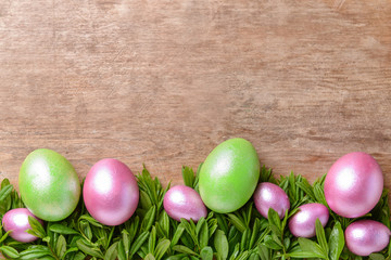 Beautiful Easter eggs on wooden background