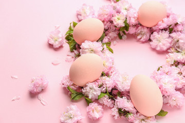 Naklejka na ściany i meble Beautiful Easter eggs with flowers on color background