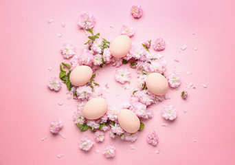 Naklejka na ściany i meble Beautiful Easter eggs with flowers on color background