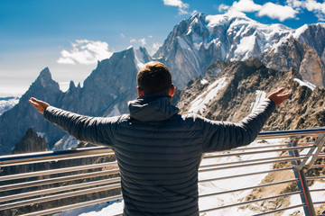 tourist looking at the mountain Mont Blanc standing on the terrace Punta Helbronner, Courmayeur Italy