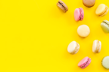 Macarons design on yellow background top view space for text