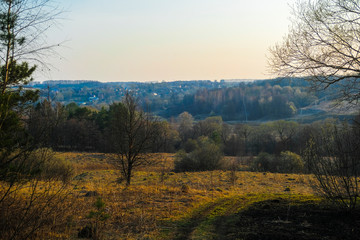 Landscape with the image of spring countryside in Tula region in Russia at sunset