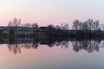 Landscape with the image of spring lake at sunset