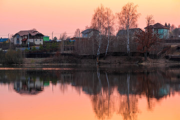 Fototapeta premium Landscape with the image of spring lake at sunset