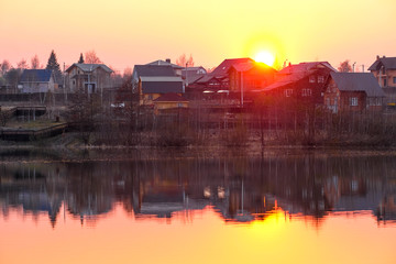 Landscape with the image of spring lake at sunset